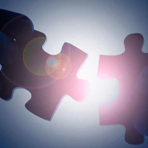 Jigsaw pieces joining together